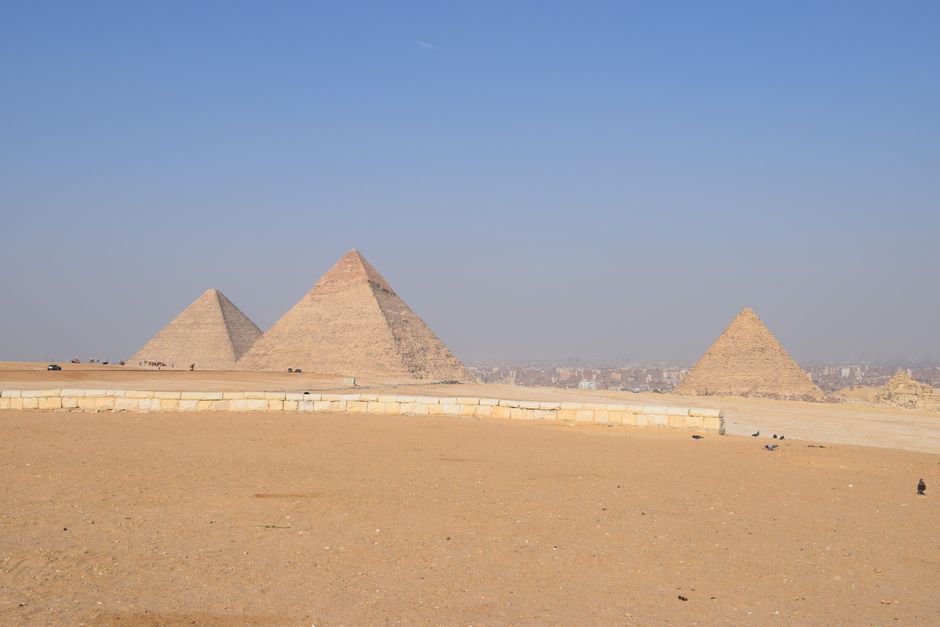 Breathtaking landscape of the Giza Pyramids under a clear blue sky in Cairo, Egypt.
