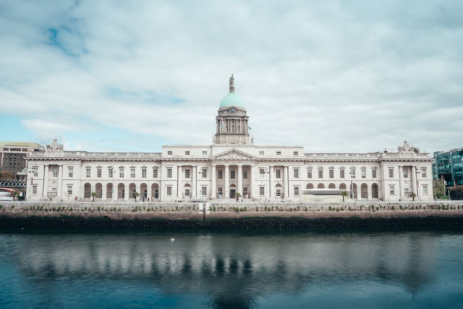 A scenic view of the historic Custom House reflecting in the River Liffey in Dublin, Ireland.