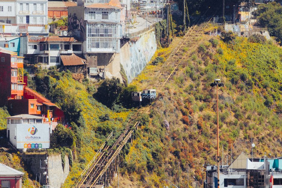 Explore the vibrant hillside architecture of Valparaíso, Chile, featuring iconic funicular railways and colorful buildings.
